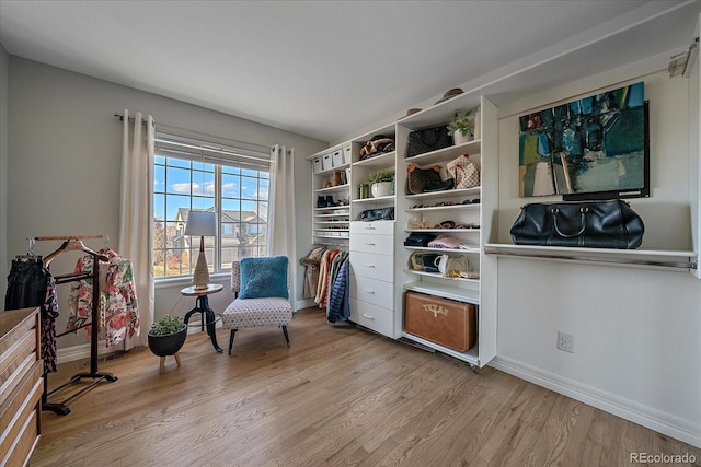 living area with baseboards and light wood finished floors