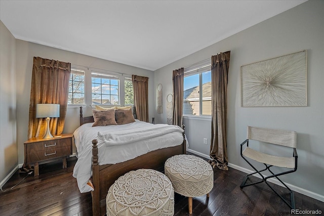 bedroom with hardwood / wood-style floors and baseboards