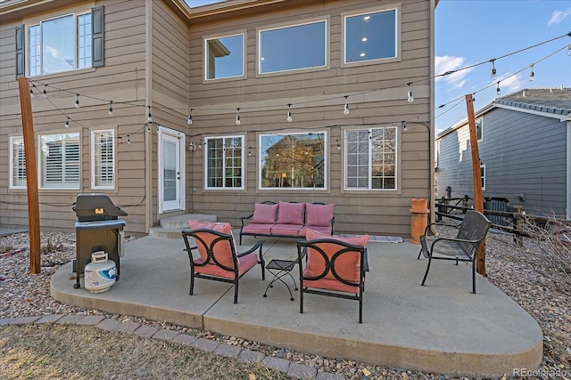 rear view of property featuring entry steps, an outdoor living space, and a patio