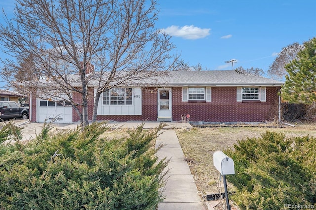 6185 Sheridan Blvd, Arvada, CO 80003 - single story home featuring brick siding, a shingled roof, an attached garage, board and batten siding, and driveway