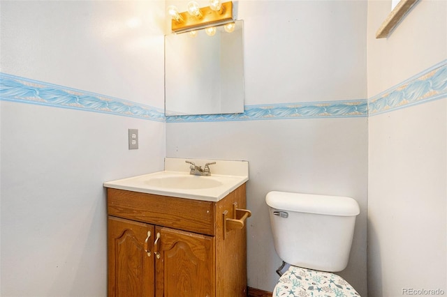 bathroom featuring toilet and vanity