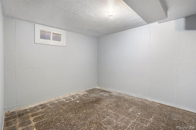 unfurnished room with a textured ceiling