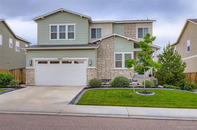 6883 E 132nd Pl, Thornton, CO 80602 - view of front of house with stone siding, a garage, and driveway