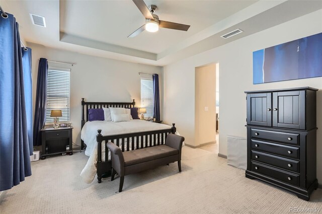 6883 E 132nd Pl, Thornton, CO 80602 - bedroom with light carpet, a raised ceiling, and ceiling fan