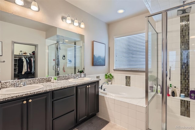 6883 E 132nd Pl, Thornton, CO 80602 - bathroom featuring a stall shower, a bath, a walk in closet, double vanity, and tile patterned floors
