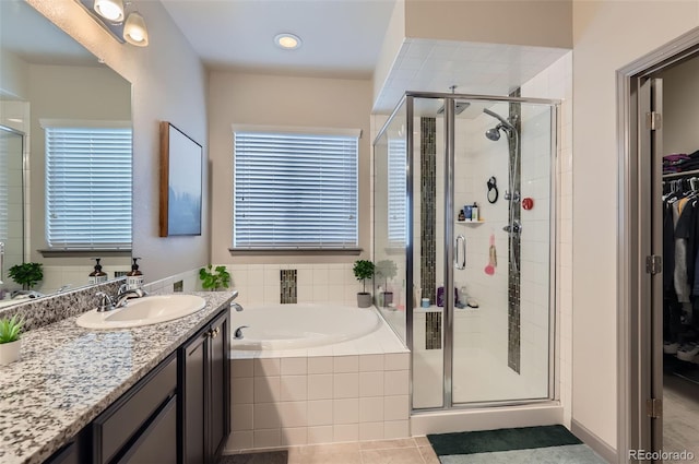 6883 E 132nd Pl, Thornton, CO 80602 - bathroom featuring a garden tub, a shower stall, vanity, and plenty of natural light