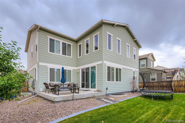 6883 E 132nd Pl, Thornton, CO 80602 - back of house with a trampoline and a patio