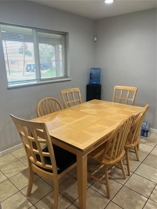 dining space featuring a wealth of natural light, baseboards, and light tile patterned floors