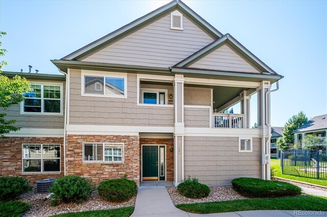 view of front of property featuring a balcony and cooling unit