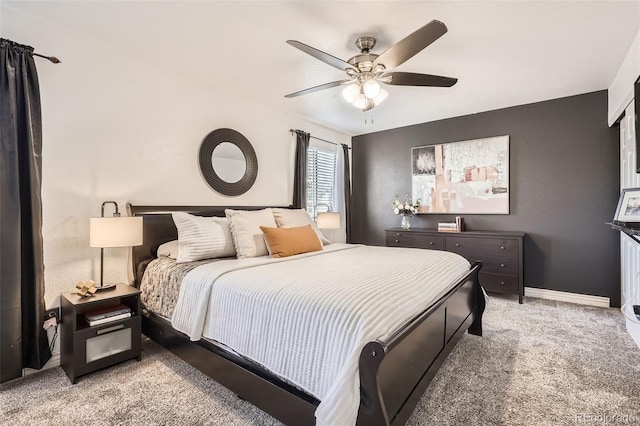 bedroom with baseboards, a ceiling fan, and light colored carpet