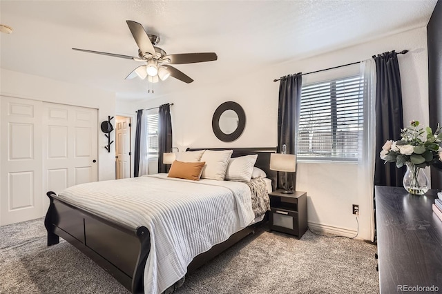 carpeted bedroom with a closet and ceiling fan