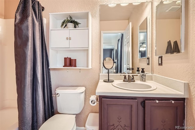 full bath with a textured wall, toilet, vanity, visible vents, and a shower with curtain