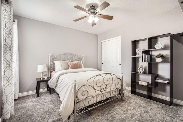 carpeted bedroom with a ceiling fan and baseboards