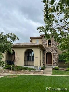 10205 Bluffmont Dr, Lone Tree, CO 80124 - mediterranean / spanish home with a front lawn, stucco siding, and a tile roof