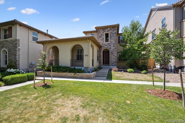 10205 Bluffmont Dr, Lone Tree, CO 80124 - mediterranean / spanish-style home with stucco siding, a front yard, and stone siding