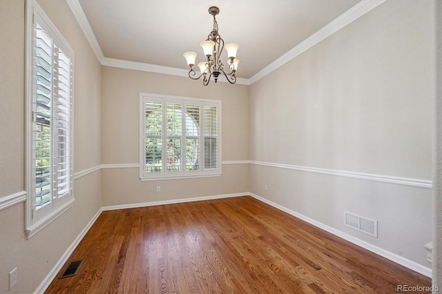 10205 Bluffmont Dr, Lone Tree, CO 80124 - spare room featuring healthy amount of natural light, a chandelier, wood finished floors, and ornamental molding