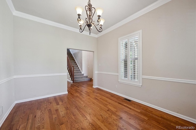 10205 Bluffmont Dr, Lone Tree, CO 80124 - unfurnished dining area featuring a chandelier, stairway, wood finished floors, and ornamental molding