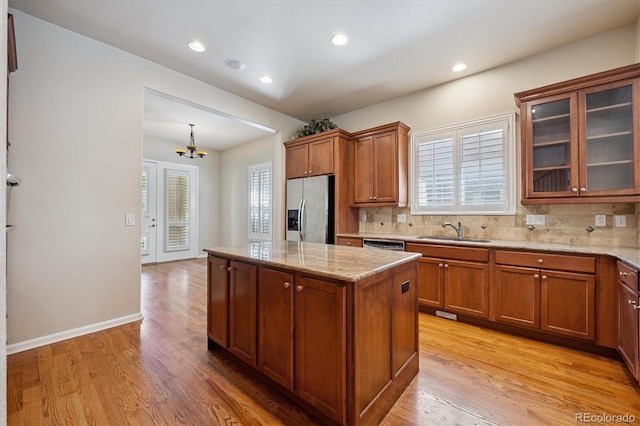 10205 Bluffmont Dr, Lone Tree, CO 80124 - kitchen with appliances with stainless steel finishes, brown cabinetry, light wood-style flooring, and recessed lighting