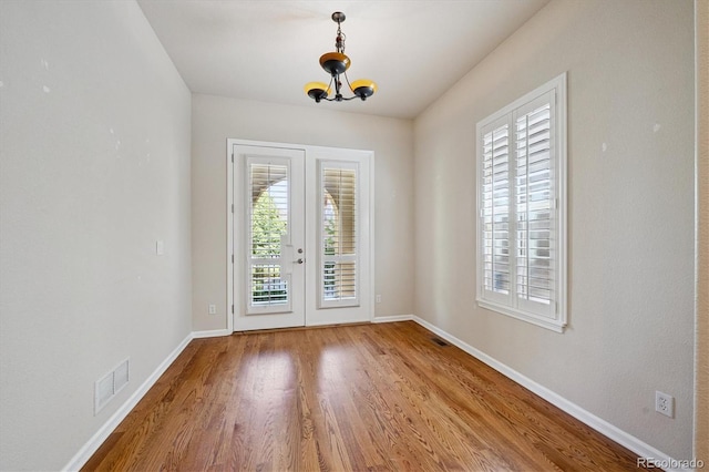 10205 Bluffmont Dr, Lone Tree, CO 80124 - empty room with a chandelier and wood finished floors