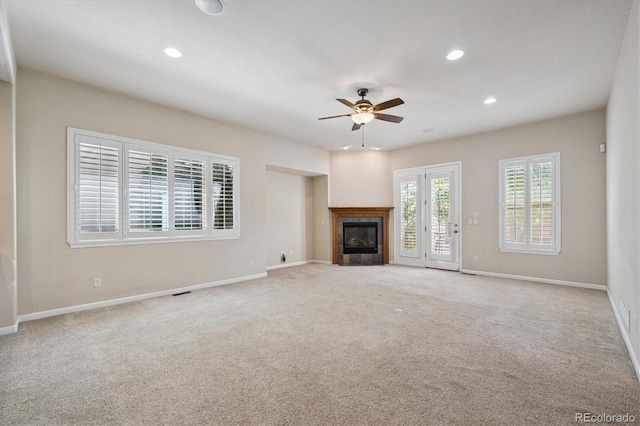 10205 Bluffmont Dr, Lone Tree, CO 80124 - unfurnished living room with a ceiling fan, a glass covered fireplace, carpet floors, and recessed lighting