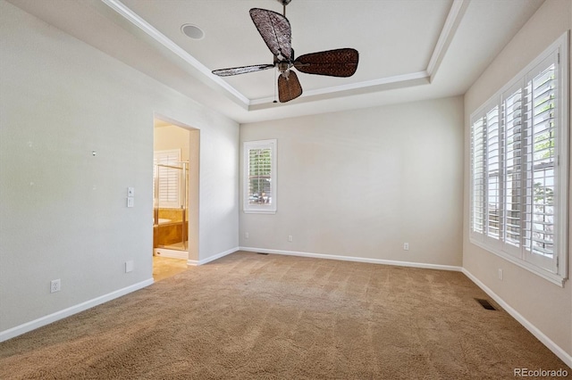 10205 Bluffmont Dr, Lone Tree, CO 80124 - empty room featuring a tray ceiling, light carpet, and ceiling fan