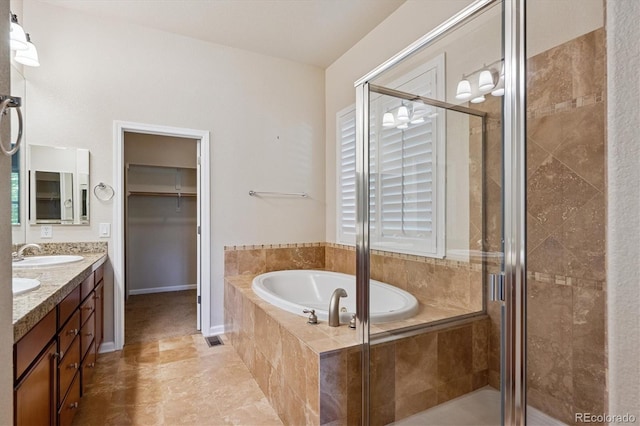 10205 Bluffmont Dr, Lone Tree, CO 80124 - bathroom with a garden tub, double vanity, a shower stall, and tile patterned flooring