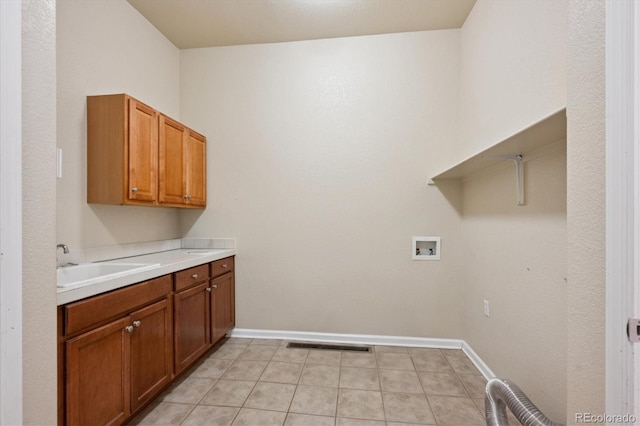 10205 Bluffmont Dr, Lone Tree, CO 80124 - laundry area featuring hookup for a washing machine, cabinet space, and light tile patterned floors