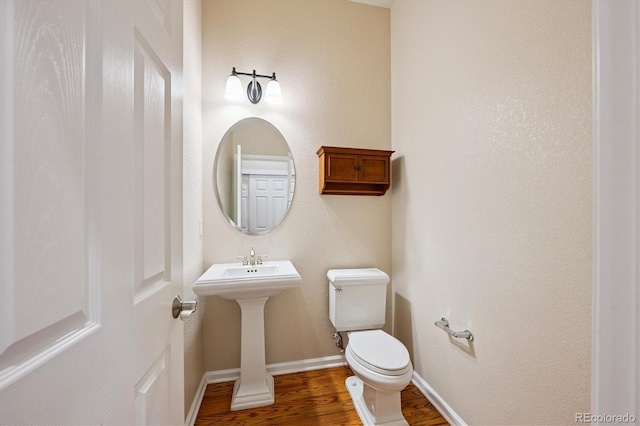 10205 Bluffmont Dr, Lone Tree, CO 80124 - half bath featuring wood finished floors and toilet