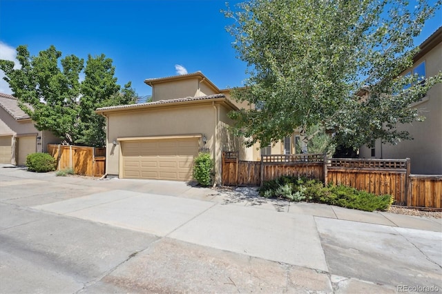 10205 Bluffmont Dr, Lone Tree, CO 80124 - view of front of house featuring driveway, a garage, and stucco siding