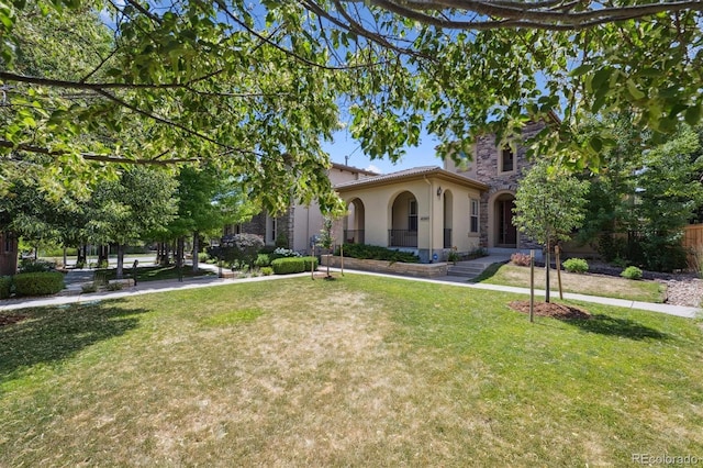 10205 Bluffmont Dr, Lone Tree, CO 80124 - mediterranean / spanish house featuring stucco siding, a front yard, and stone siding