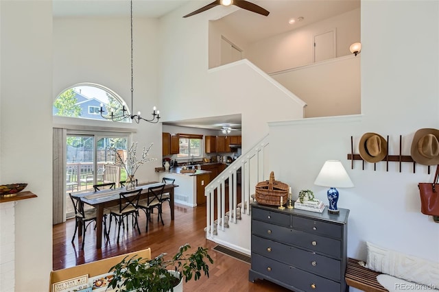 728 Poppywood Pl, Highlands Ranch, CO 80126 - stairway with ceiling fan, a towering ceiling, a chandelier, and wood finished floors