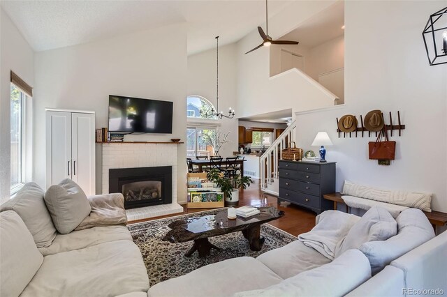 728 Poppywood Pl, Highlands Ranch, CO 80126 - living area featuring stairway, a ceiling fan, wood finished floors, a fireplace, and high vaulted ceiling