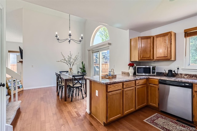 728 Poppywood Pl, Highlands Ranch, CO 80126 - kitchen with appliances with stainless steel finishes, brown cabinetry, and plenty of natural light