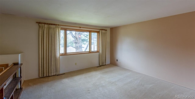 unfurnished room with light carpet and visible vents