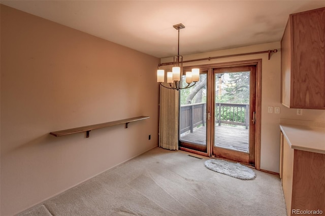 interior space featuring light colored carpet, baseboards, a notable chandelier, and visible vents