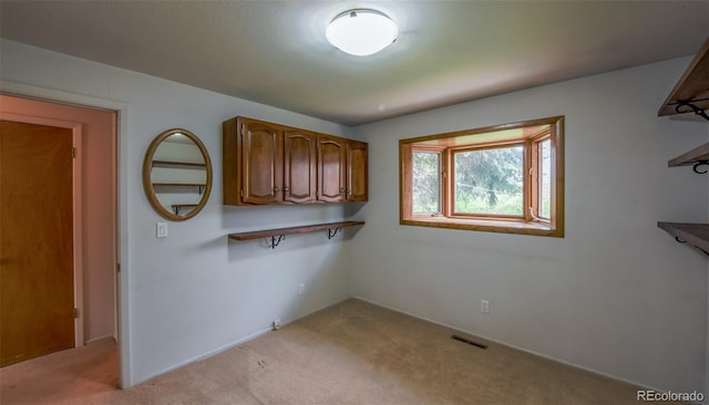 washroom with visible vents, baseboards, and light carpet