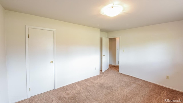 unfurnished bedroom featuring light carpet