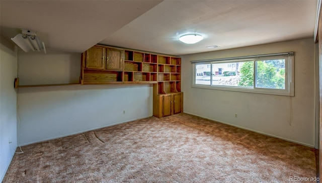 carpeted empty room with baseboards and visible vents