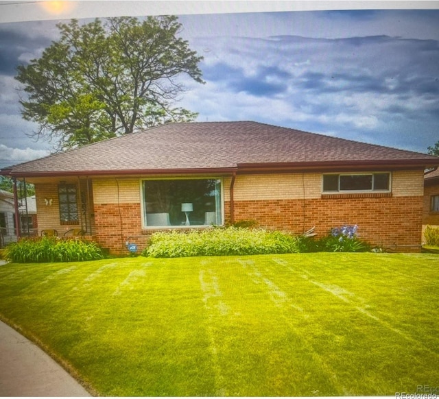 back of house with a lawn