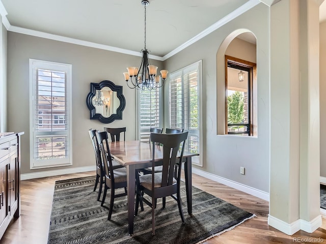 5092 S Allison Way, Littleton, CO 80123 - dining room with arched walkways, plenty of natural light, wood finished floors, crown molding, and a chandelier
