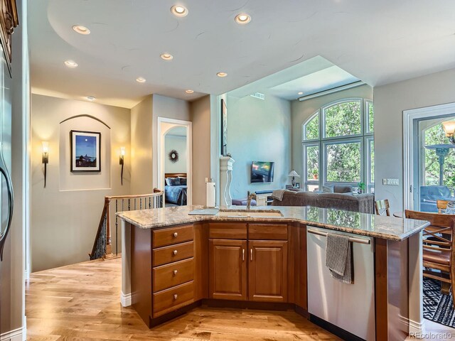5092 S Allison Way, Littleton, CO 80123 - kitchen with dishwasher, brown cabinetry, recessed lighting, light stone countertops, and light wood-style floors
