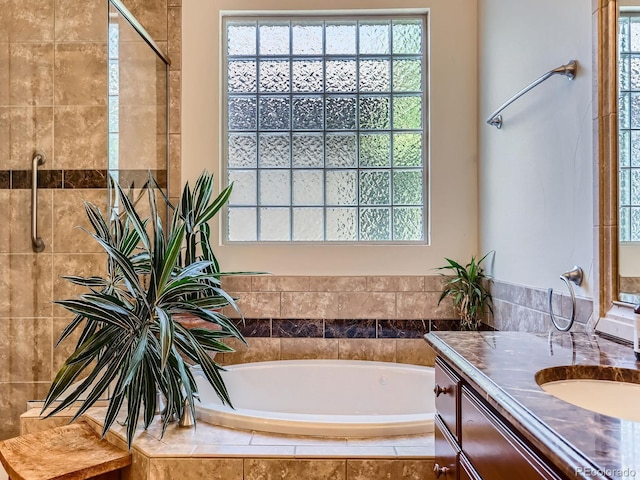 5092 S Allison Way, Littleton, CO 80123 - full bathroom featuring a garden tub, vanity, healthy amount of natural light, and tiled shower