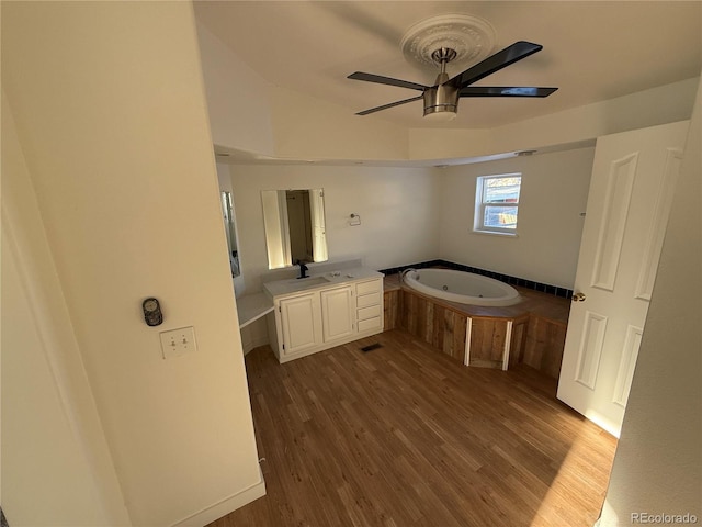 bathroom featuring vanity, a bathtub, wood-type flooring, and ceiling fan