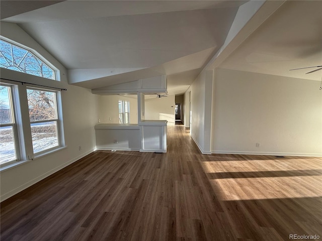 empty room with ceiling fan, vaulted ceiling, and hardwood / wood-style floors