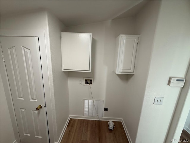 clothes washing area featuring cabinets, hookup for a washing machine, dark wood-type flooring, and hookup for an electric dryer