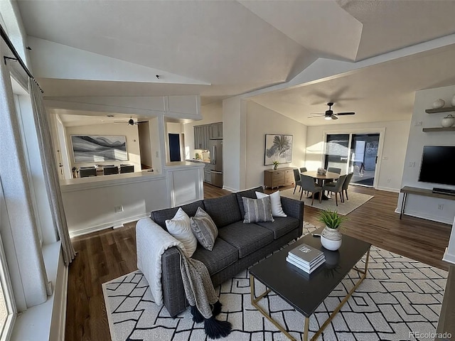 living room with hardwood / wood-style flooring, vaulted ceiling, and ceiling fan