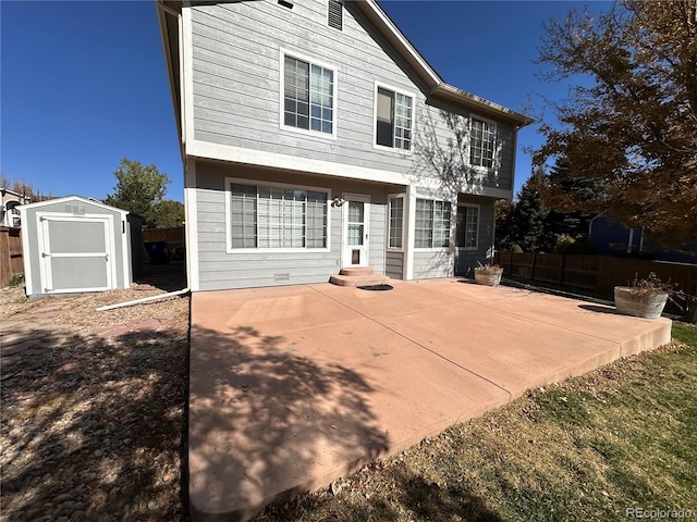 back of property featuring a patio and a shed