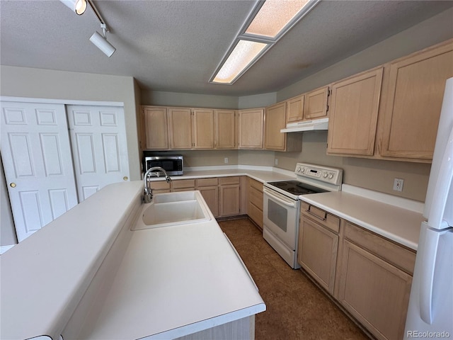 kitchen featuring light brown cabinetry, sink, a textured ceiling, and white appliances