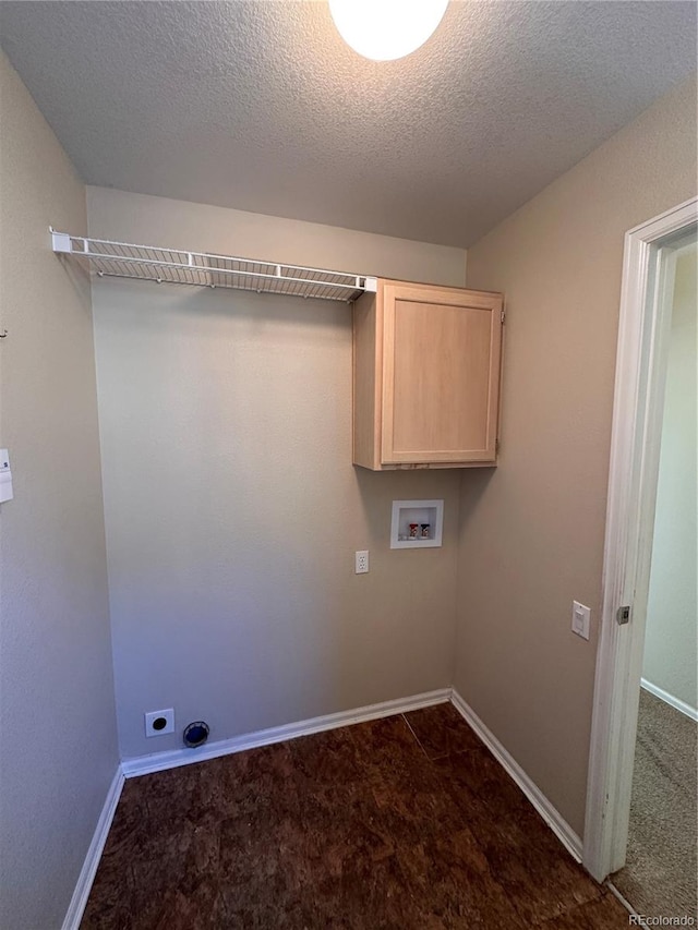 laundry room with cabinets, hookup for an electric dryer, a textured ceiling, and washer hookup