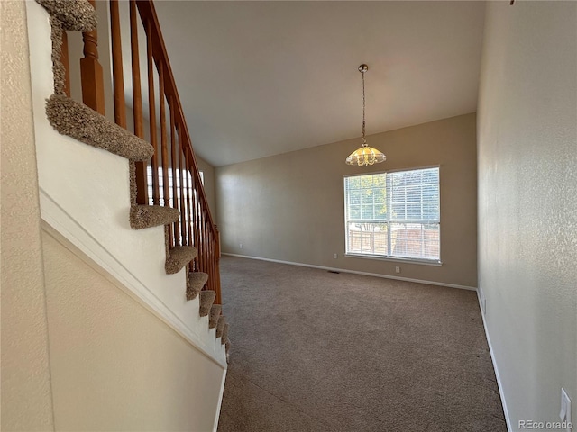 interior space with carpet flooring and vaulted ceiling